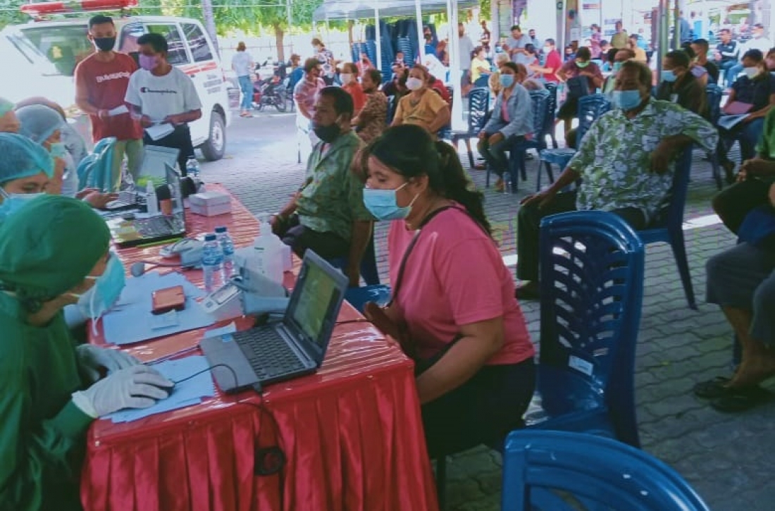 Petugas sedang melakukan skrining pada masyarakat sebelum memberikan vaksinasi